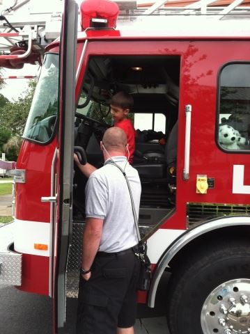 Firefighter Showing Boy Fire Truck